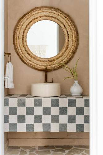 a mirror on top of a counter with a sink at Secluded Luxury Mansion with Sleek, Modern Design, High-End Amenities, and Spectacular Views in Carpintero