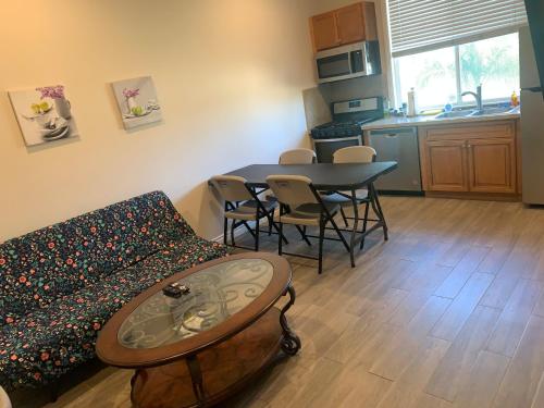 a living room with a couch and a table at High End Triplex with Pool in Riverside