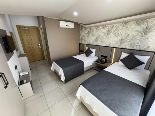 Postel nebo postele na pokoji v ubytování Sardunya Hotel