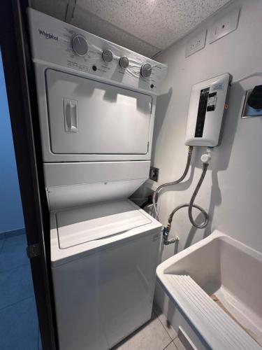 a small white refrigerator with its door open at View 15, San Francisco Tower in San Salvador