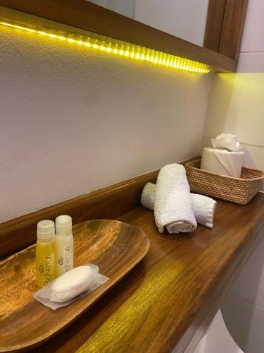 a bathroom counter with a plate and a sink at Hotel Pelecanus Suites Holbox in Holbox Island