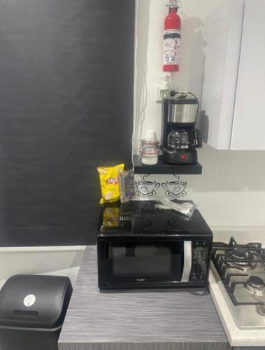 a microwave sitting on a counter in a kitchen at Perfect suite #1 in San Juan