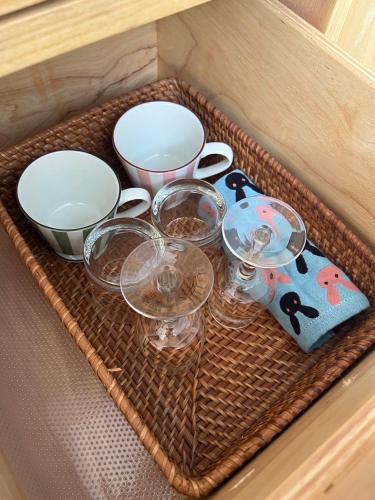 a tray with bowls and cups on a table at Heaven77 in Ban Sap Phrik