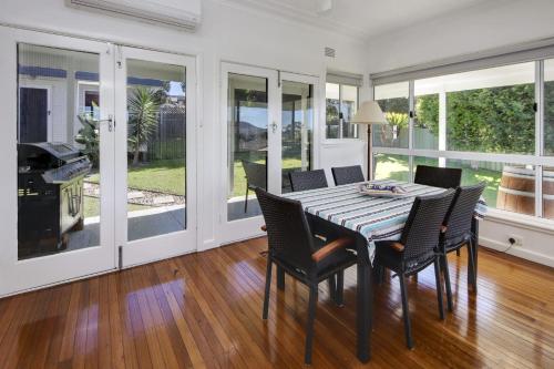 a dining room with a table and chairs at Summer Salt - 13-15 Sturt Street South West Rocks in South West Rocks