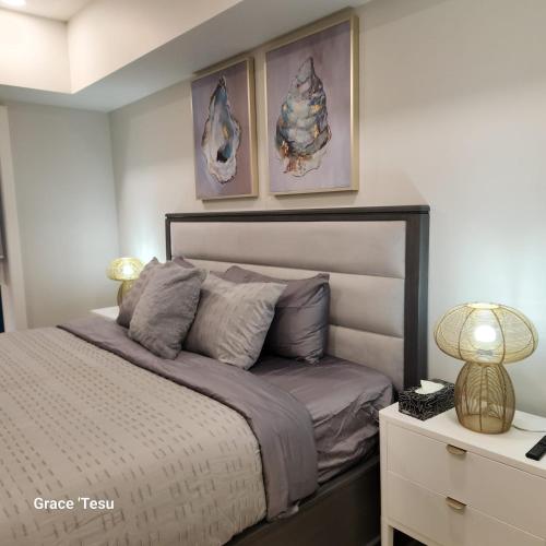 a bedroom with a bed with two pictures on the wall at Cozy Cove Retreat Escape to Tranquility Stay in Simplicity in Dead Man's Flats