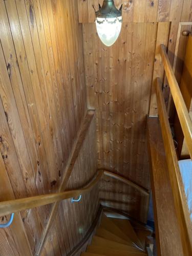 an inside view of a wooden cabin with a staircase at Namibian Sun - Seehaus in Stäfa