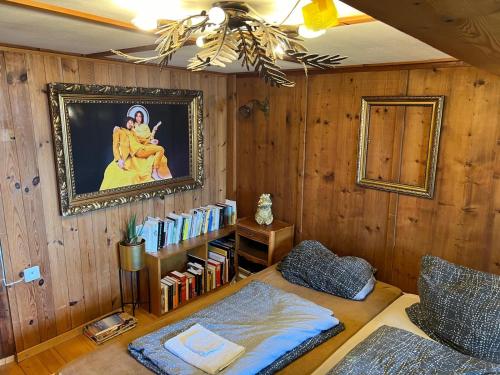 a room with a book shelf filled with books at Namibian Sun - Seehaus in Stäfa