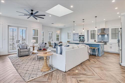 a living room with a white couch and a kitchen at Seashells to Sandcastles 156 BAR in Mustang Beach