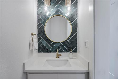 a bathroom with a sink and a mirror at Seashells to Sandcastles 156 BAR in Mustang Beach