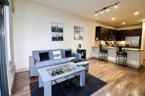 a living room with a couch and a table at Houston Midtown Luxury in Houston
