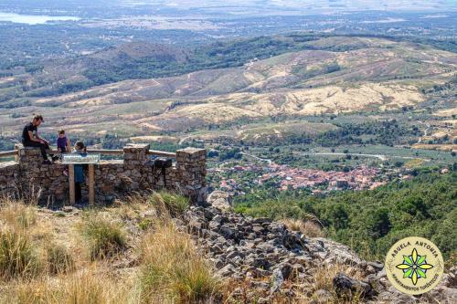 two people sitting on a table on top of a mountain at AT la abuela Antonia- Ca Pablo in Torre de Don Miguel