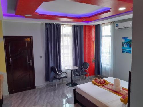 a room with a bed and a ceiling with purple lights at Mazola Diamond Hotel in Dar es Salaam