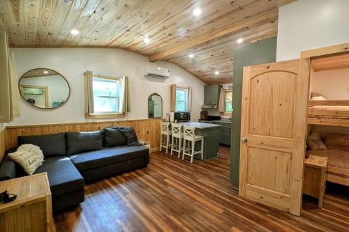 a living room with a couch and a kitchen at River Retreat Cabin - Living Water Farm in Cleveland