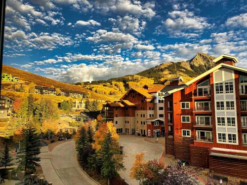 a town in the mountains with trees and buildings at Studio 565 Perfect Location with Pool and Hot Tub in Crested Butte