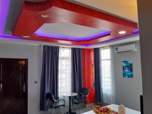 a room with a false ceiling with purple lights at Mazola Diamond Hotel in Dar es Salaam