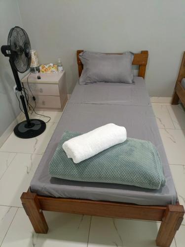 a bedroom with two beds with a pillow and a fan at Fitz & Oritz Homestay in Nanguilé