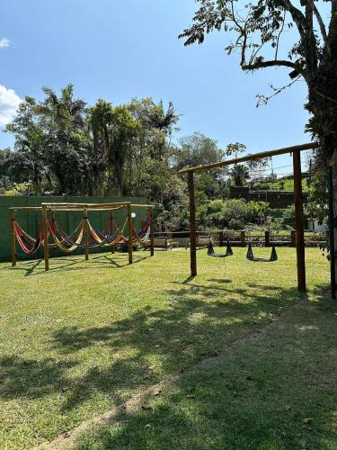 a playground with hammocks in a park at Gaia Hotelaria in Teresópolis