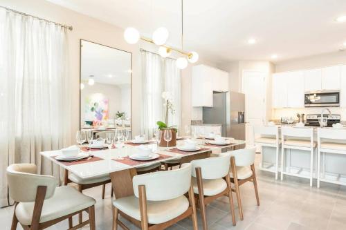 a kitchen and dining room with a table and chairs at 7988 Magical 5BD Home Perfect Disney Retreat in Kissimmee