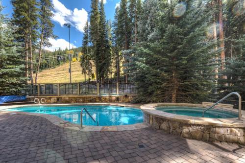 a swimming pool in the middle of a yard with trees at Lone Eagle 3017 in Keystone