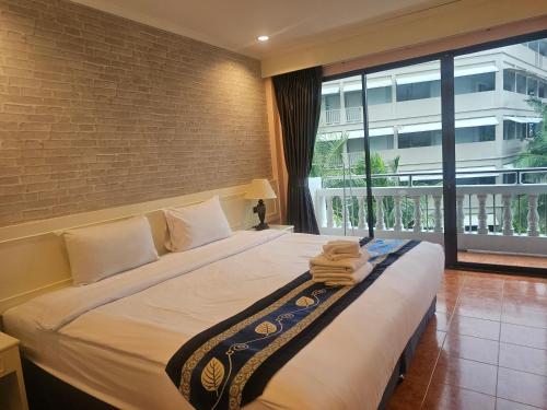 a hotel room with a bed with towels on it at Patong Central Residence & Apartment in Patong Beach
