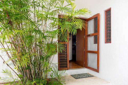a door to a house with plants in front of it at Casita Sunray Private pool and beach access, King beds in Akumal