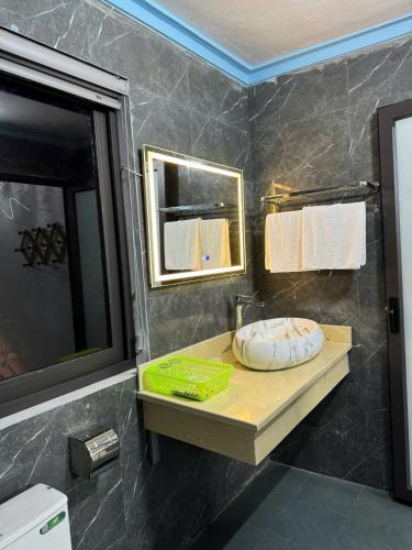 a bathroom with a sink and a mirror at Tam Coc Charming Bungalow in Ninh Binh