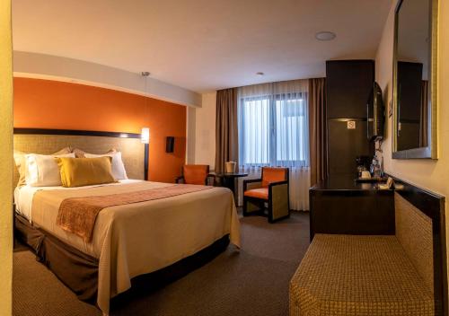 a hotel room with a bed and a desk at Hotel Catedral in Mexico City