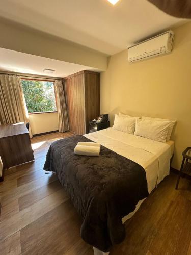 a hotel room with a large bed in a room at Gaia Hotelaria in Teresópolis