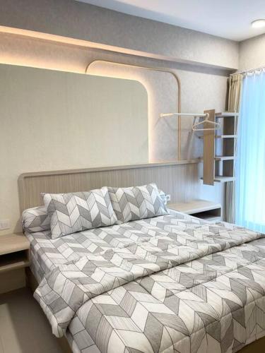 a bedroom with a large bed in a room at Aesthetic korean apartment 2 BR in Surabaya