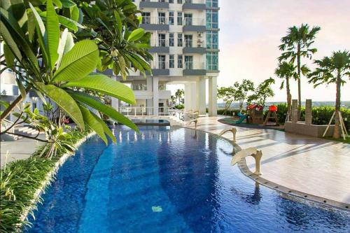 a swimming pool in front of a building at Aesthetic korean apartment 2 BR in Surabaya