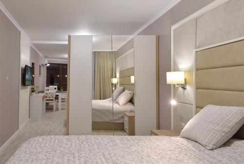a hotel room with two beds and a mirror at Divona Studio in Ruse