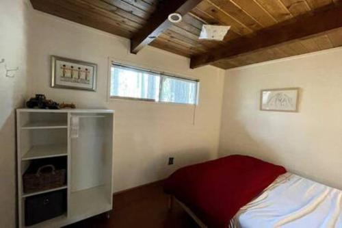 a small bedroom with a bed and a window at Pinecrest A-Frame Family fun near Dodge Ridge in Long Barn