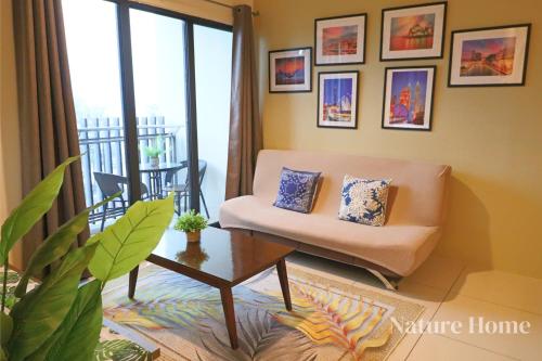 a living room with a couch and a table at Nature Home - Swiss Garden Resort Residences in Kuantan