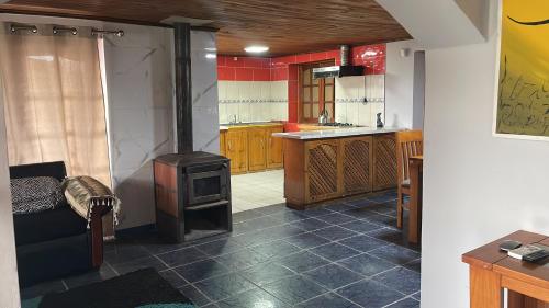 a kitchen with a stove in the middle of a room at Casa Yerbas Buenas in Yerbas Buenas