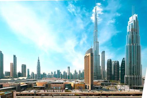 a view of a large city with skyscrapers at Stylish Burj khalifa view 5 Star 4BD Apartment in Downtown with Dubai Mall access - Brand New Apartment in Dubai