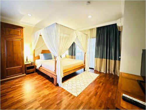 a bedroom with a bed with a canopy at Cyberview Resort & Spa in Cyberjaya