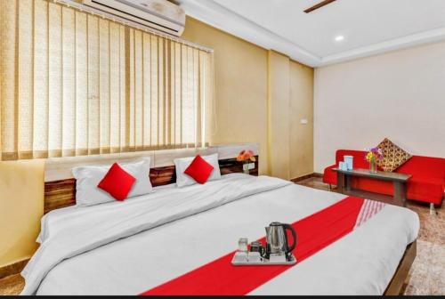 a bedroom with a large bed with red and white pillows at Lavish residency near to Rammurthynagar main road in Bengaluru