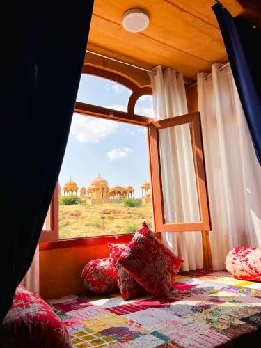 a room with a window with a view of a desert at Hotel Royal Heritage in Jaisalmer