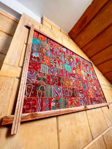 a colorful rug on the side of a wall at Hotel Royal Heritage in Jaisalmer