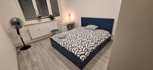 a bedroom with a bed with a black and white comforter at Family apartment Kramare in Bratislava