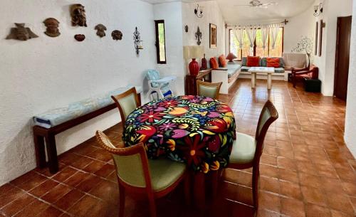 a living room with a table and chairs and a couch at Casita Sunray Private pool and beach access, King beds in Akumal