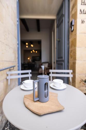a table with two cups and saucers on it at Harbour Mansion in Birgu