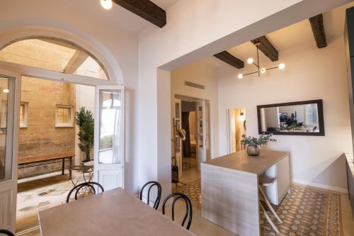 a kitchen and dining room with a table and chairs at Harbour Mansion in Birgu