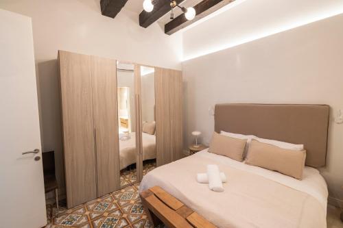 a bedroom with a bed with two candles on it at Harbour Mansion in Birgu