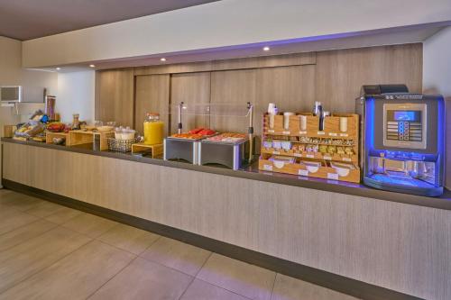 a buffet line in a hotel room with food at City Express Junior by Marriott Mexicali in Mexicali
