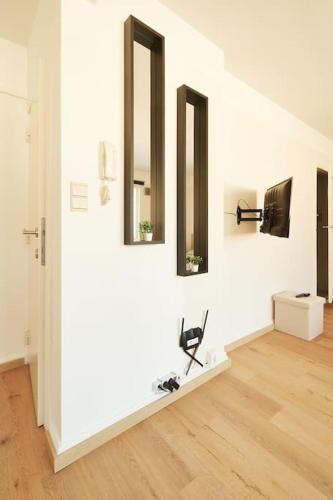 a white room with three mirrors on the wall at Studio-balcon center of Mons in Mons