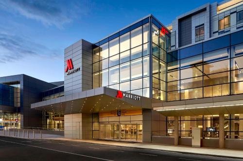 a large glass building with a sign on it at Calgary Airport Marriott In-Terminal Hotel in Calgary