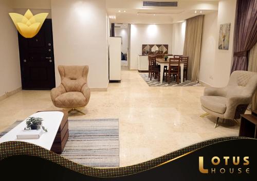 a living room with two chairs and a table at El Lotus Building in Cairo