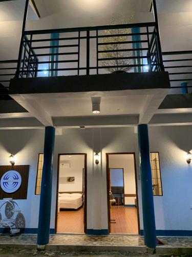 a house with a staircase and a room with a bed at Camiguin Atlantis Pension House in Catarman