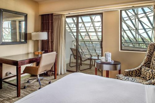 a hotel room with a bed and a desk at Crowne Plaza Hotel St. Louis Airport by IHG in Bridgeton